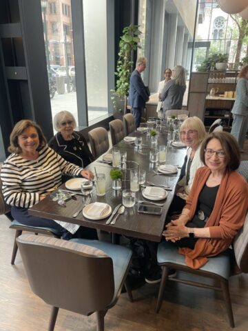 diners at table posing for photo