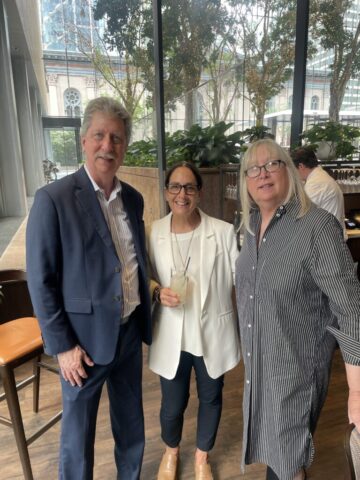 three people standing and posing for a photo